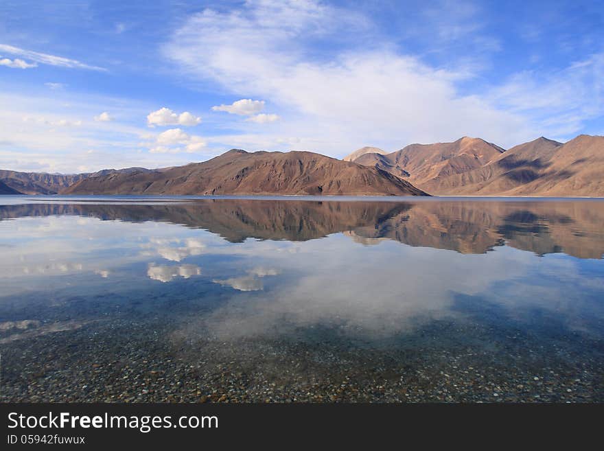 Pangong lake (Pangong Tso) is an endorheic lake in the Himalayas situated at a height of about 4,350 m (14,270 ft). It is 134 km (83 mi) long and extends from India to Tibet. Pangong lake (Pangong Tso) is an endorheic lake in the Himalayas situated at a height of about 4,350 m (14,270 ft). It is 134 km (83 mi) long and extends from India to Tibet.