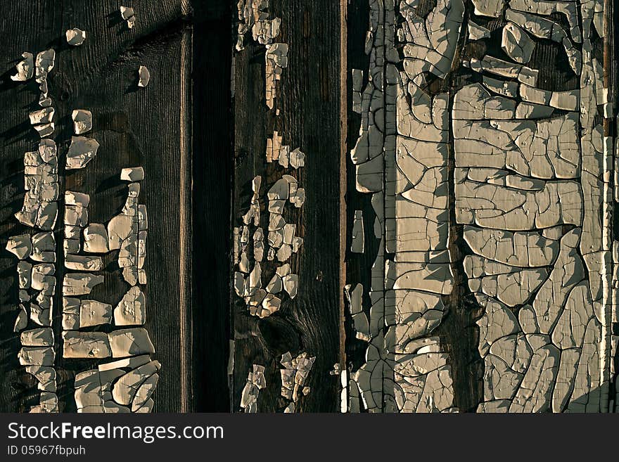 Old wooden wall with old peeled-off paint as a background