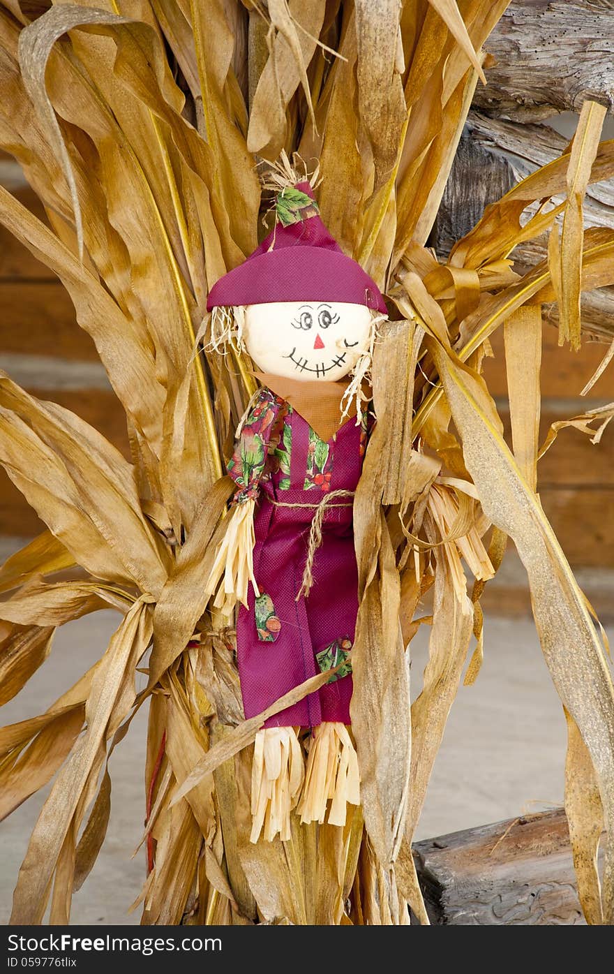 Fall Decorations With Scarecrow And Hay Stack.