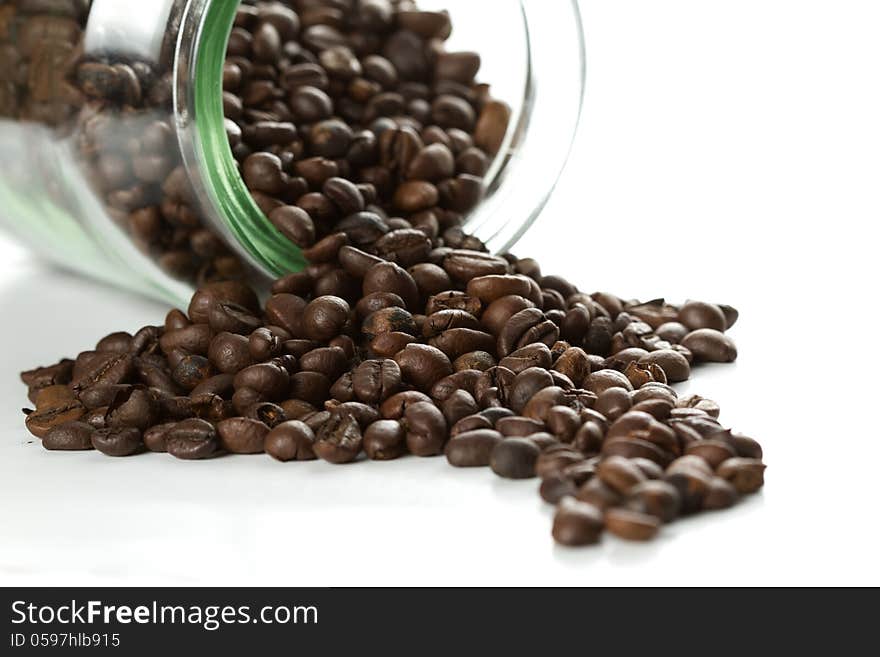 Coffee beans in a bottle on white background. Coffee beans in a bottle on white background