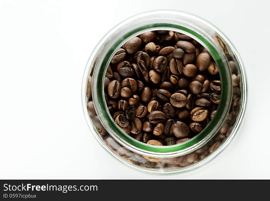 Coffee beans in a bottle on white background. Coffee beans in a bottle on white background