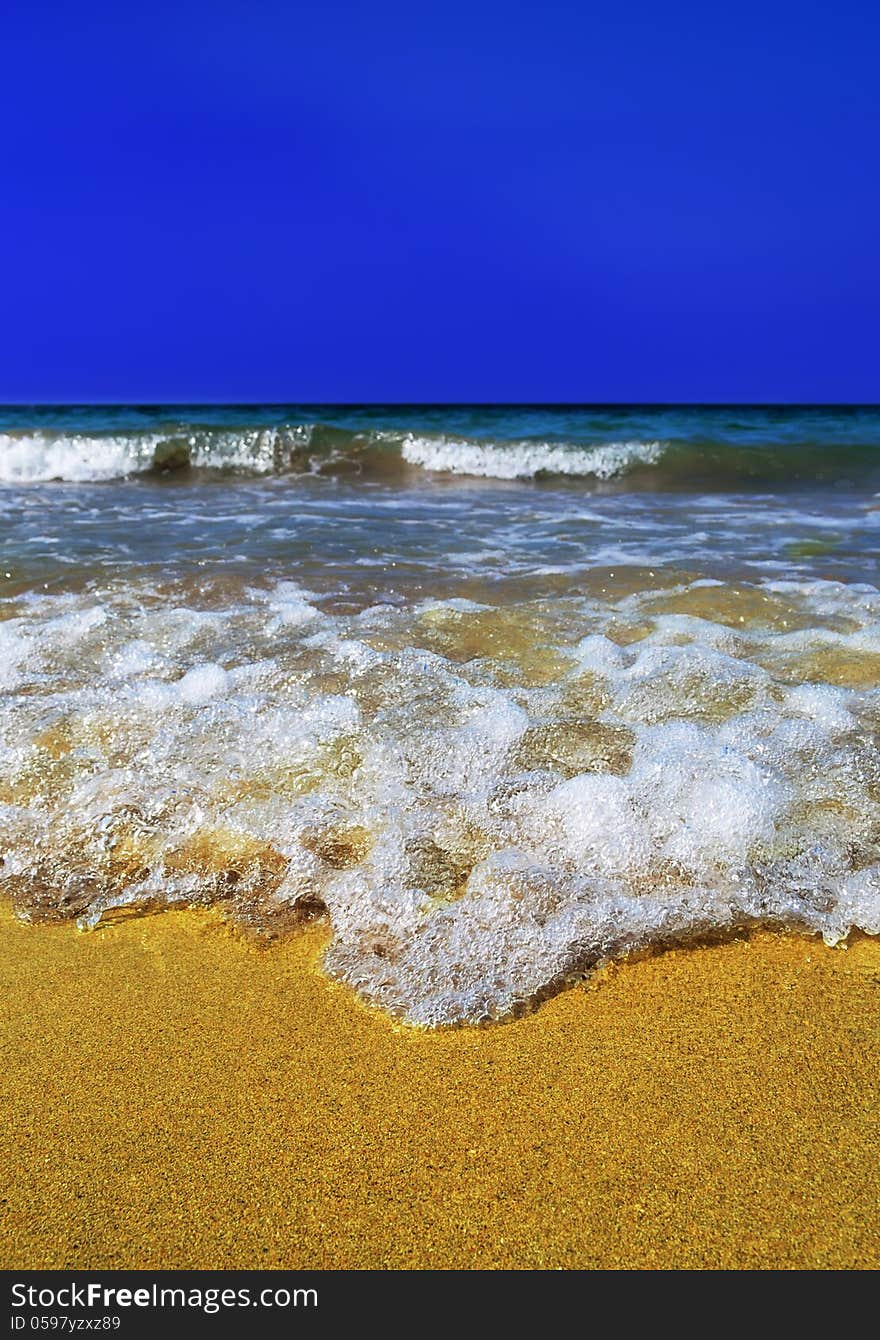 Sea wave in the yellow sand