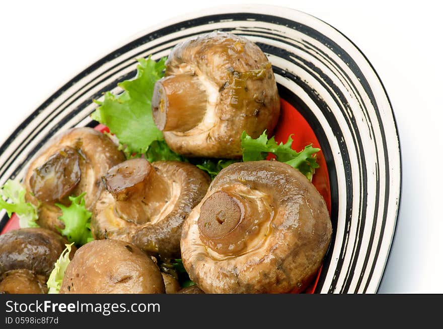 Big Roasted Champignon Mushrooms with Greens on Plate cross section  on white background. Big Roasted Champignon Mushrooms with Greens on Plate cross section  on white background