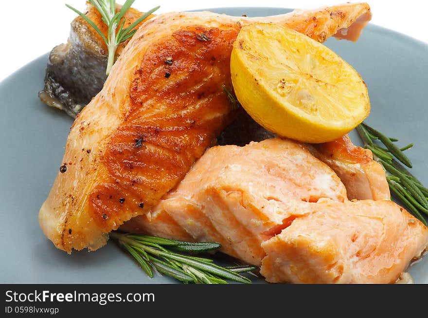 Stack of Grilled Salmon with Rosemary and Lemon closeup on Green Plate