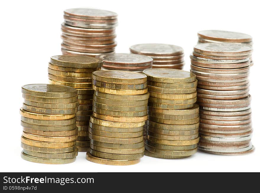 Stacks of Silver and Gold Coins closeup isolated on white background. Stacks of Silver and Gold Coins closeup isolated on white background