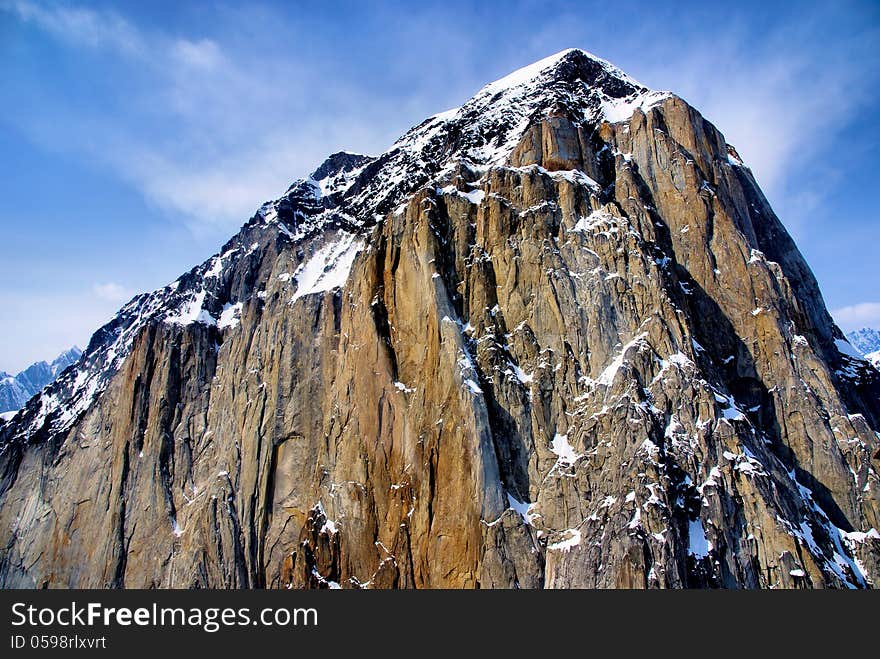 Stark outcropping of granite rock jutting out of the cold Alaskan landscape. Stark outcropping of granite rock jutting out of the cold Alaskan landscape.