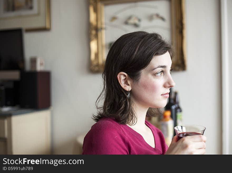 Young Woman with Beautiful Green Eyes Drinking Wine