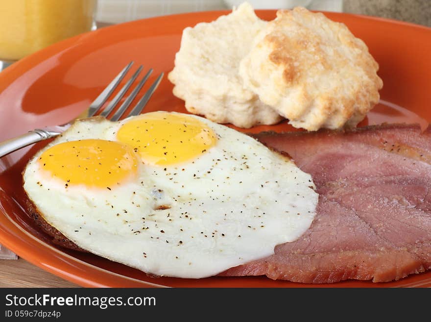 Slice of ham with fried eggs on a plate. Slice of ham with fried eggs on a plate