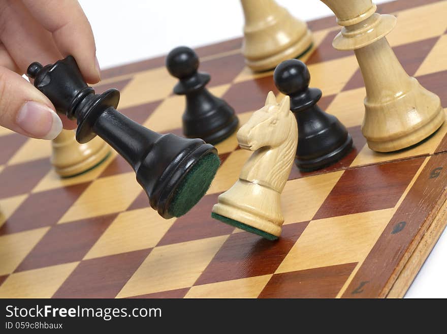 Picture shows a chess game. The horse is hitting by queen. Studio light. Picture shows a chess game. The horse is hitting by queen. Studio light.