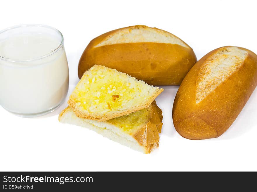 Two loaves of french baguette and a glass of milk and garlic bread, on white background. Two loaves of french baguette and a glass of milk and garlic bread, on white background