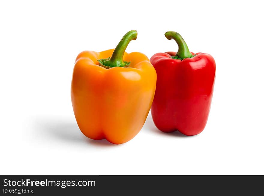 Fresh colored peppers on white background