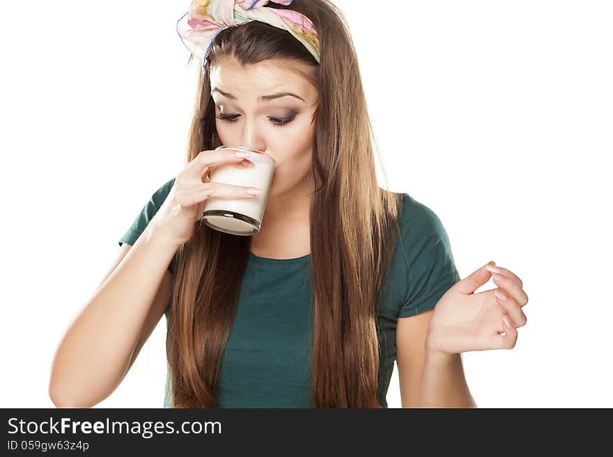 Girl drinks milk or yogurt in glass cups and gesticulating with the eyes as it is tasty. Girl drinks milk or yogurt in glass cups and gesticulating with the eyes as it is tasty