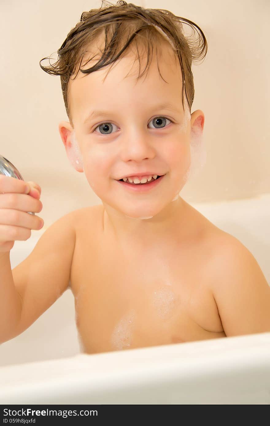 Cute three year old boy taking a bath. Cute three year old boy taking a bath