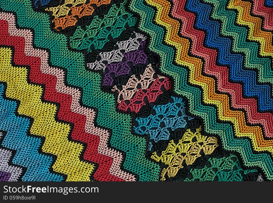 Detail of colorful knitted blankets pillows. Detail of colorful knitted blankets pillows