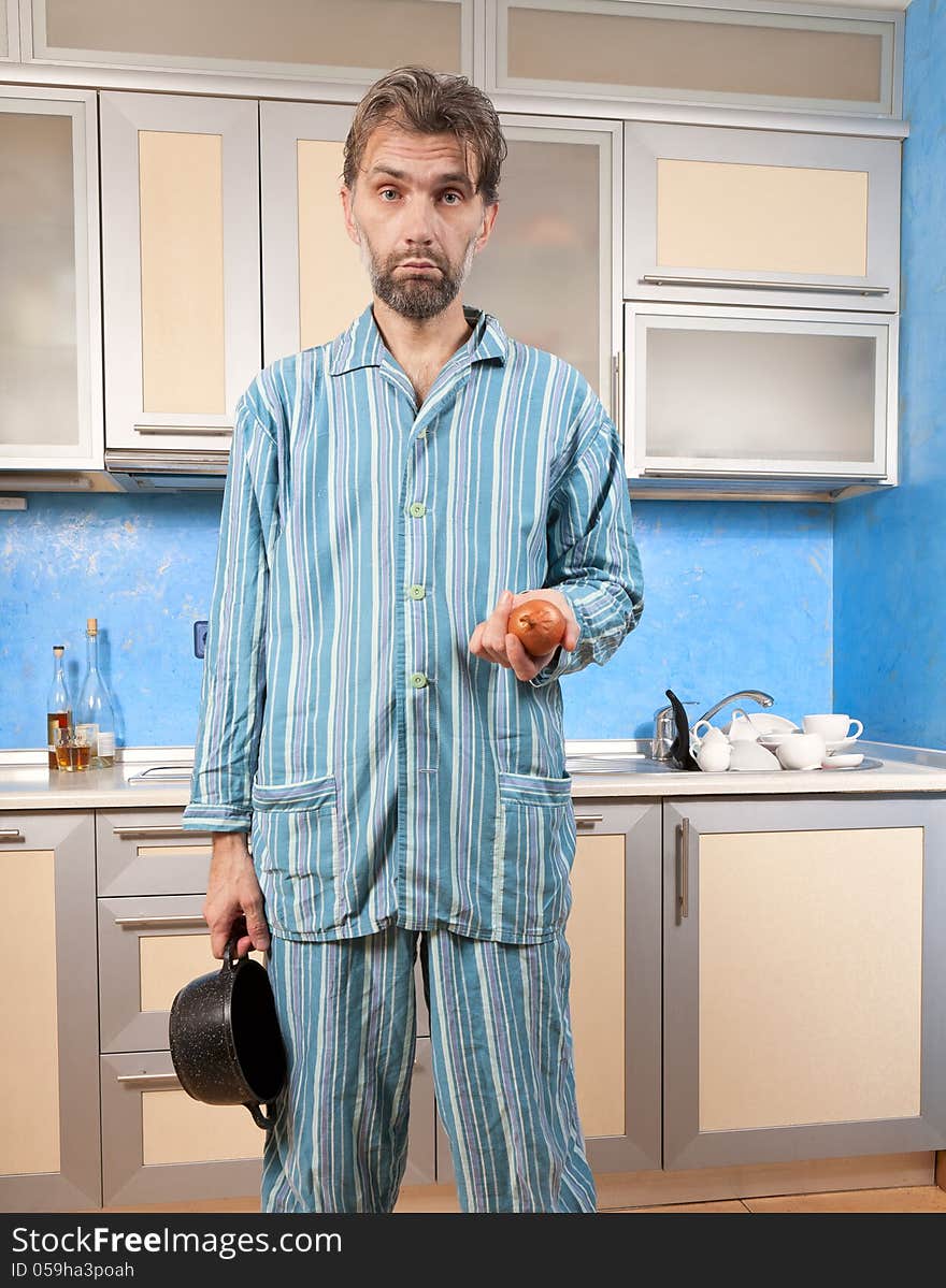 Drunk man standing in pajamas with onion