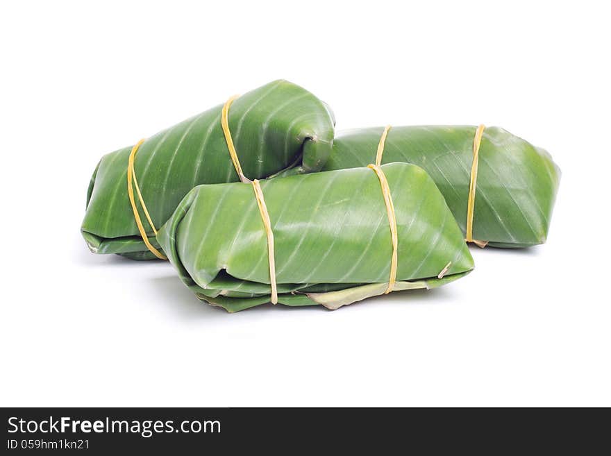 Sour pork in banana leaf on white background