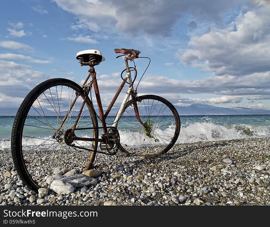 A rusty classic bike at seaside of a beach in Greece. A rusty classic bike at seaside of a beach in Greece