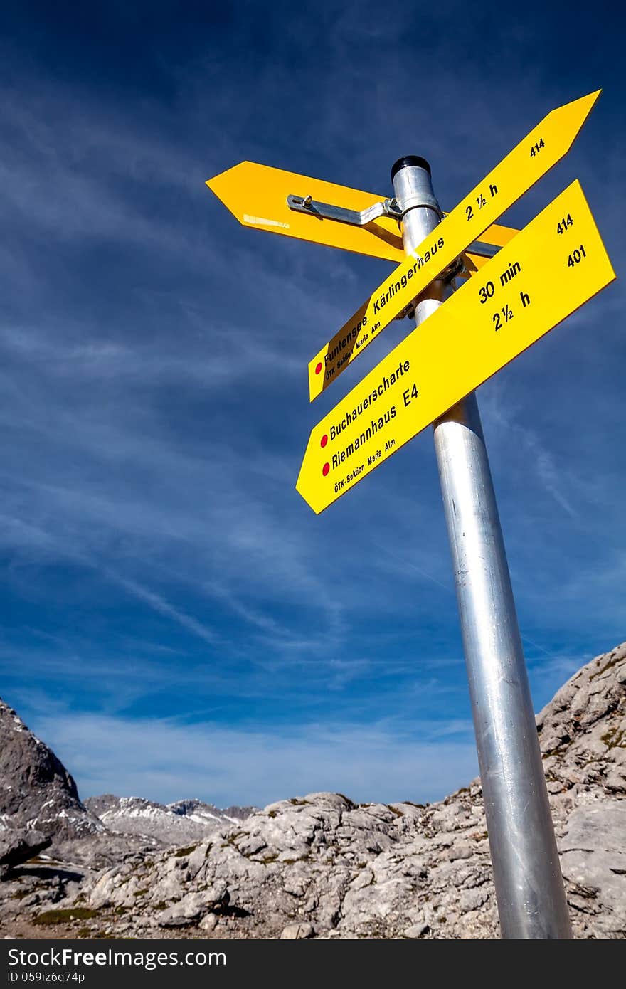 Yellow sign-board against mountain scenery of Germany Alps