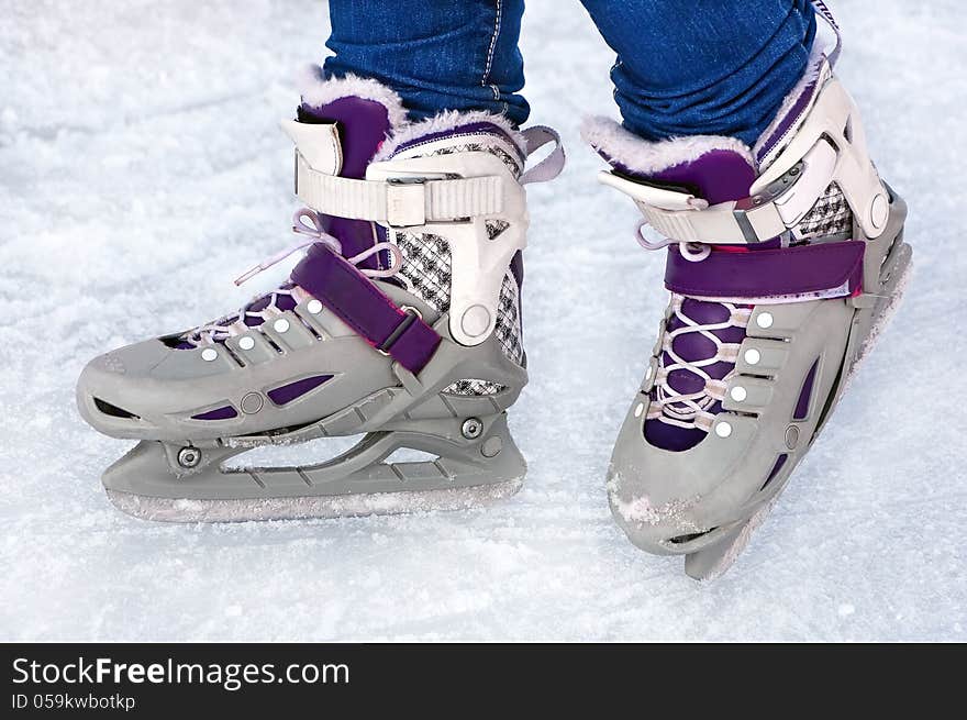 Feet in the figure skaters performing on ice. Feet in the figure skaters performing on ice