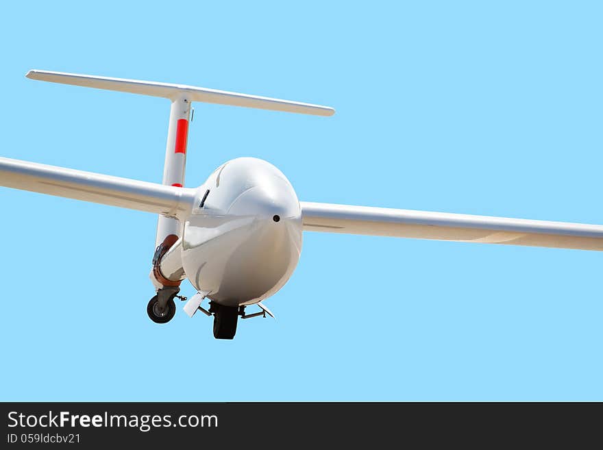 White airplane on clear blue sky in flight