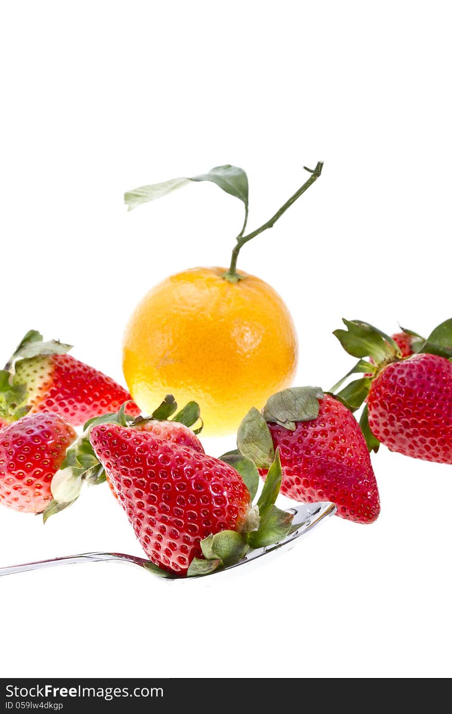 Orange with strawberries and a spoon on white background. Orange with strawberries and a spoon on white background