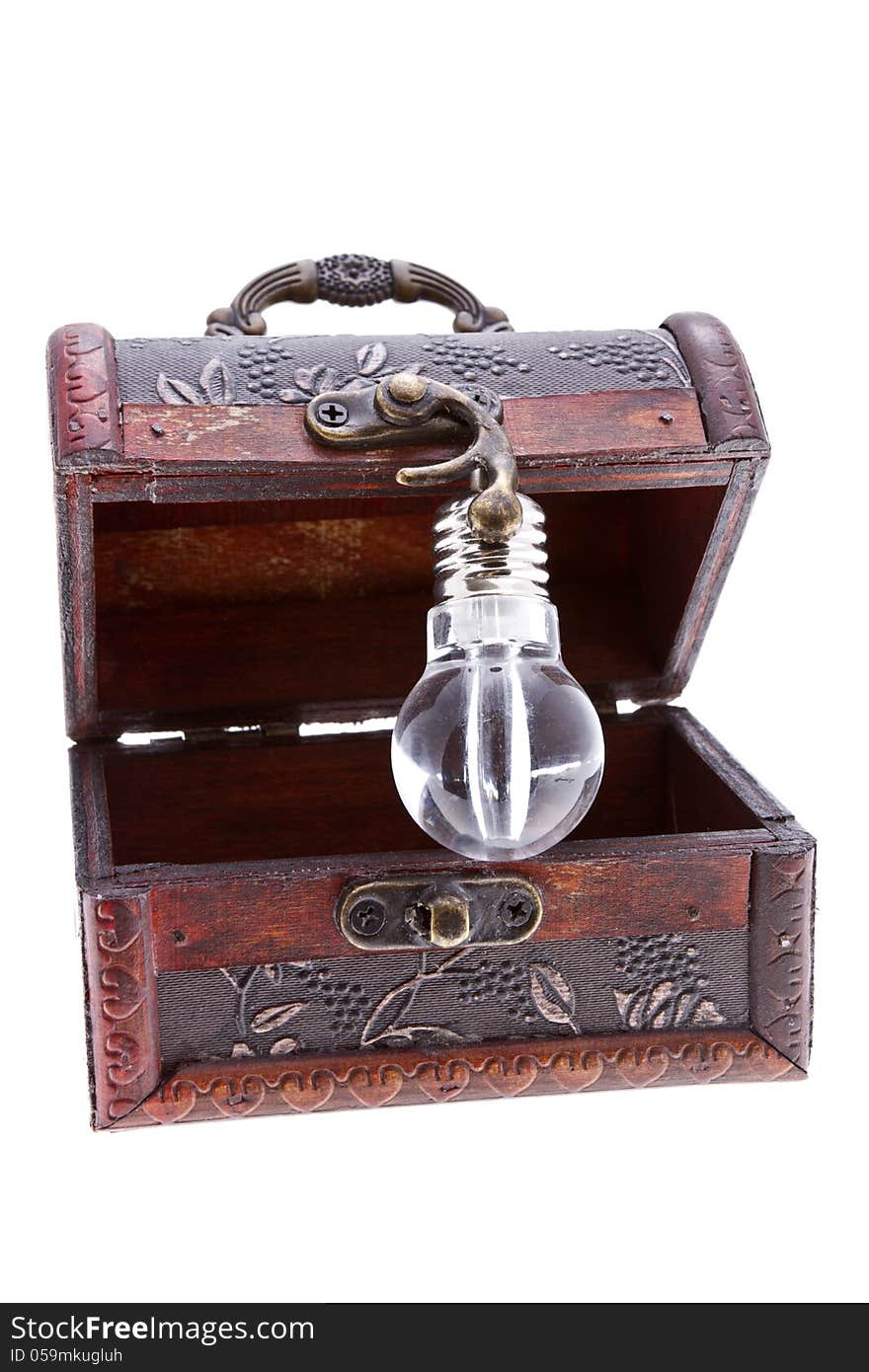 Idea lamp inside of a treasure chest isolated on white. Idea lamp inside of a treasure chest isolated on white