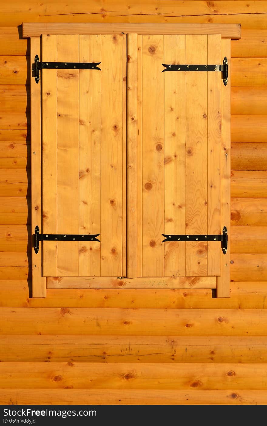 Closed window on wooden wall of a chalet