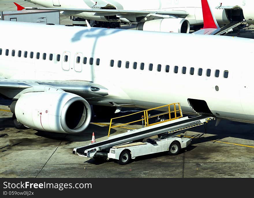 Aircraft on the airfield prepairing for the flight and loading cargo