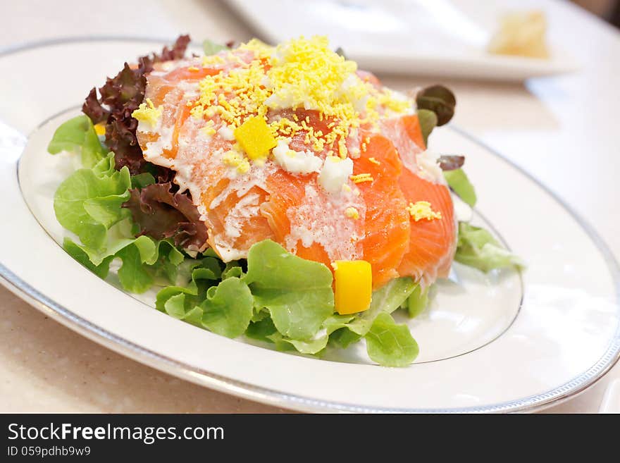 Image of Smoke salmon salad on white dish