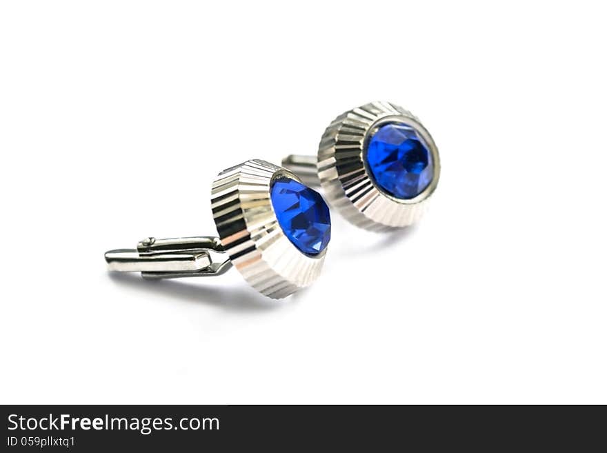 Cufflinks with blue gems on white background