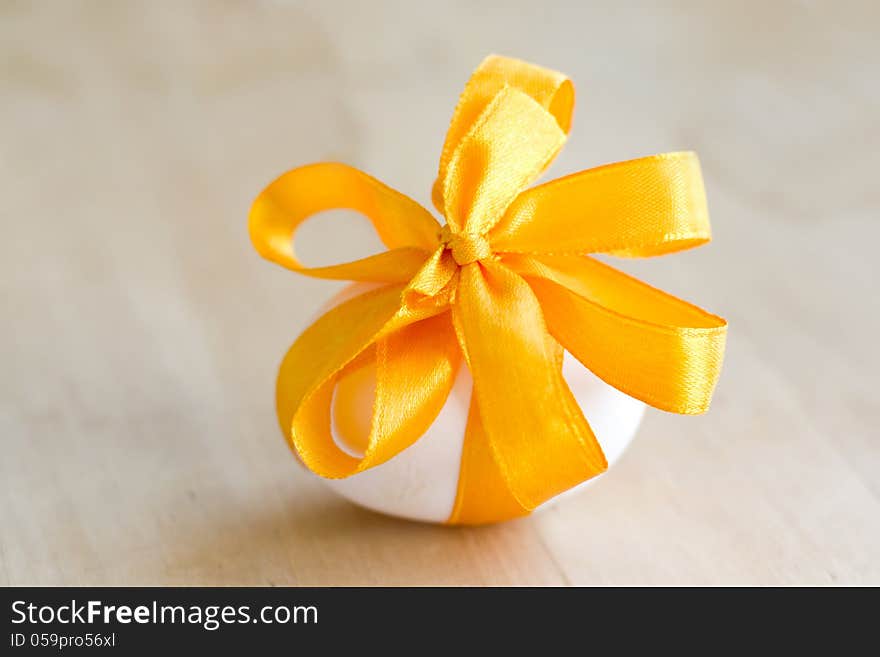 Easter egg, tied with a yellow ribbon