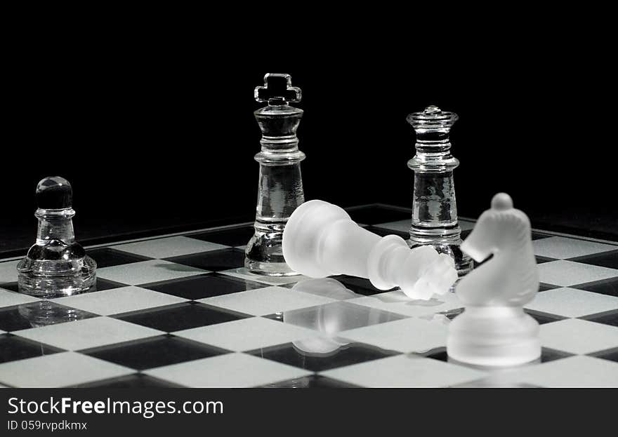 Final pieces in a chess game – Checkmate. Selective focus on down king.