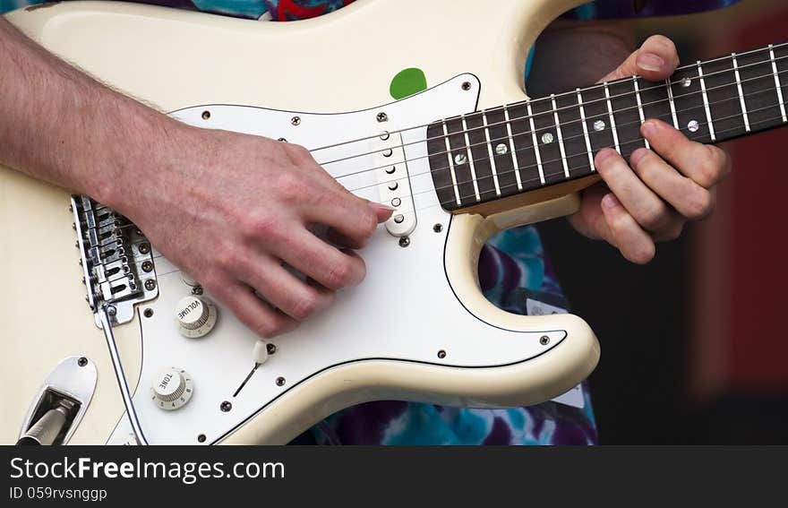 Closeup of a electric guitar and musician picks out some slick riffs. Closeup of a electric guitar and musician picks out some slick riffs