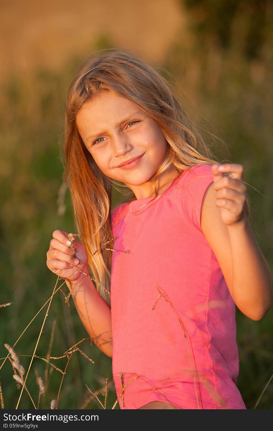 Girl standing in the grass. Girl standing in the grass