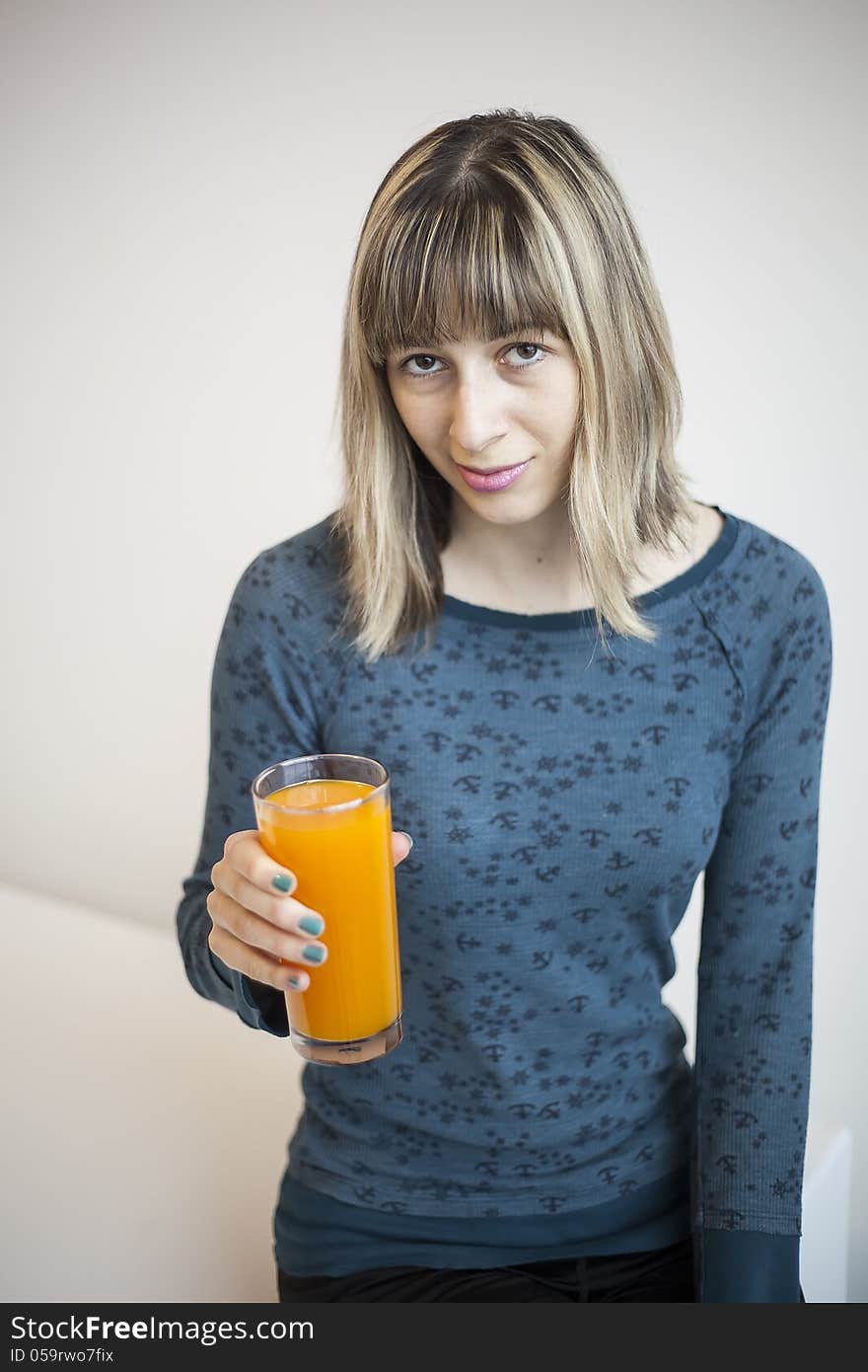 Young Woman Drinking Mango Juice