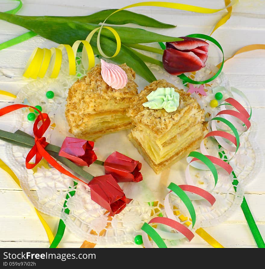 Two pieces of cakes with tulip flowers and colorful ribbon. Two pieces of cakes with tulip flowers and colorful ribbon