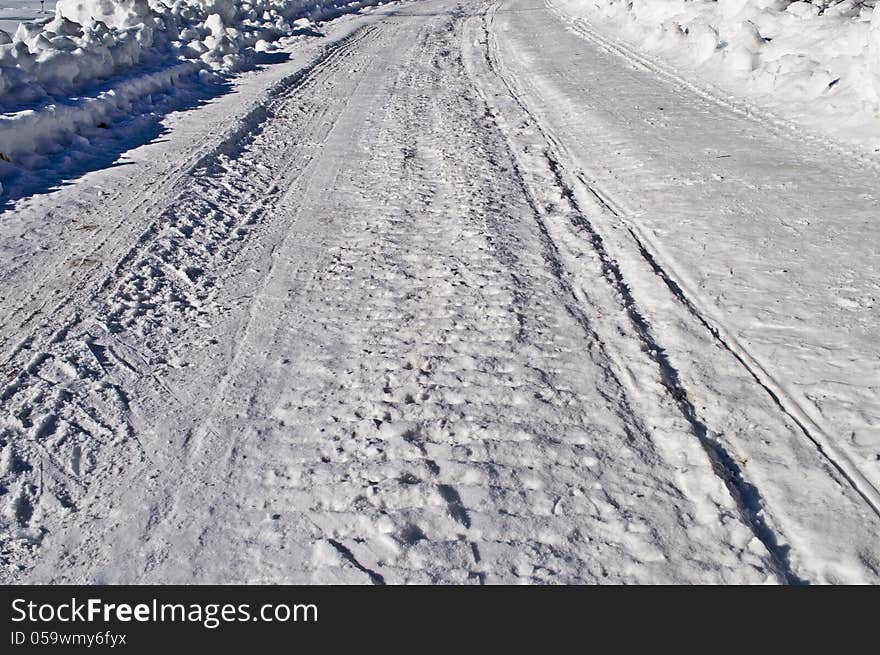 Close up of snowy road background, winter sunny day