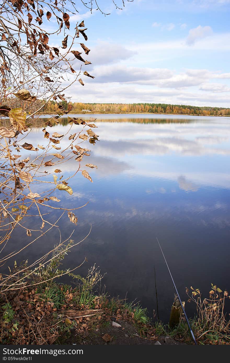 Landscape with lake, woods and sky