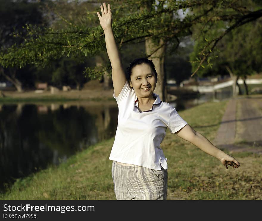 Woman Doing Morning Exercises In The Park