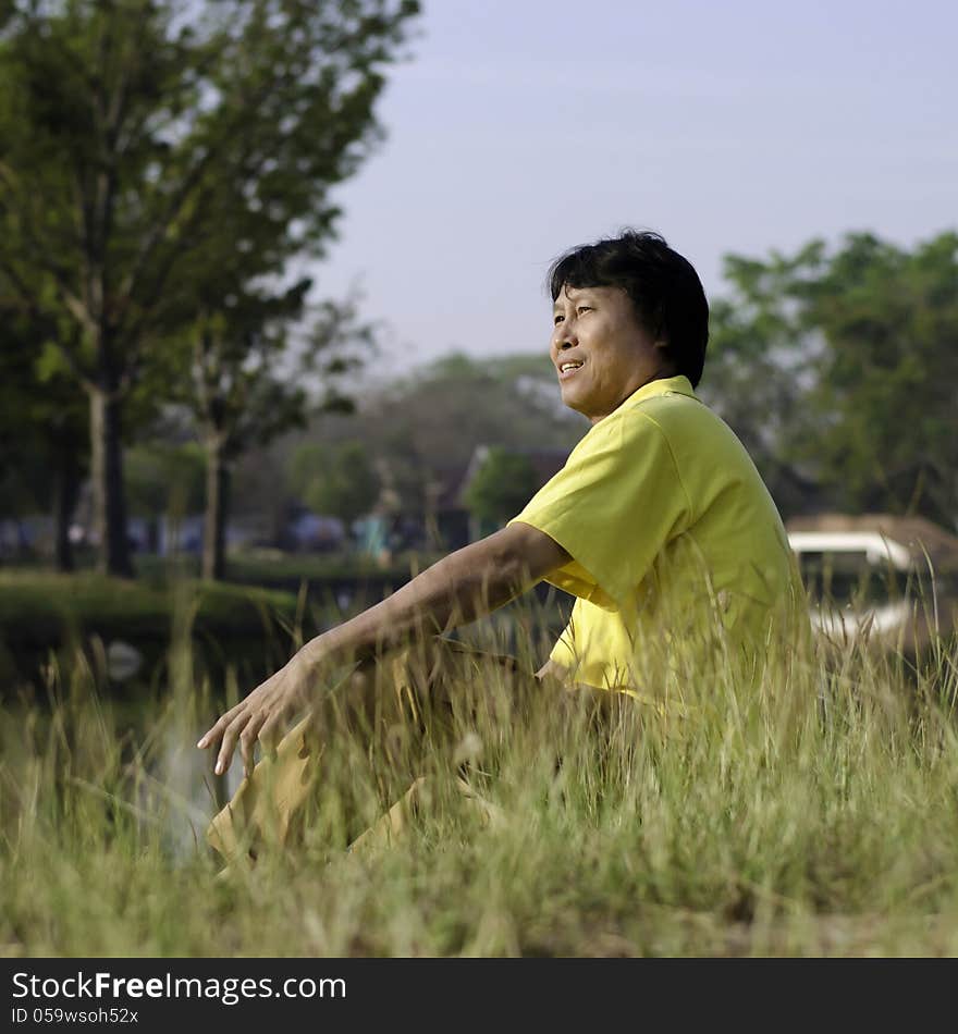 Happy asian middle-aged man in the park