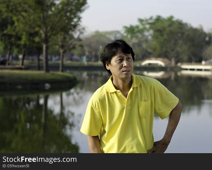 A portrait of a senior south asian man by lake