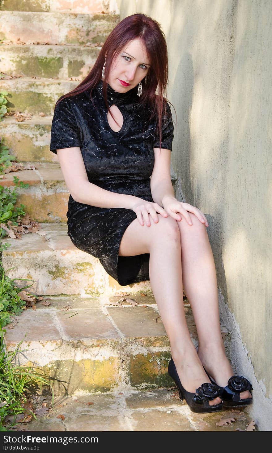 Young woman sitting on staircase