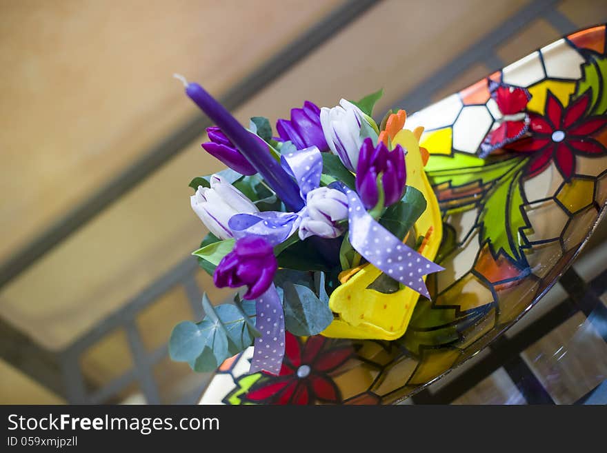 Purple tulips and candle in Easter ornament