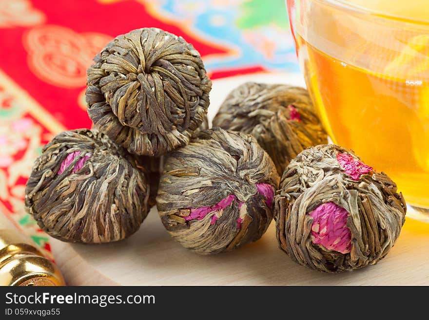 Chinese green tea balls with flowers, tea cup