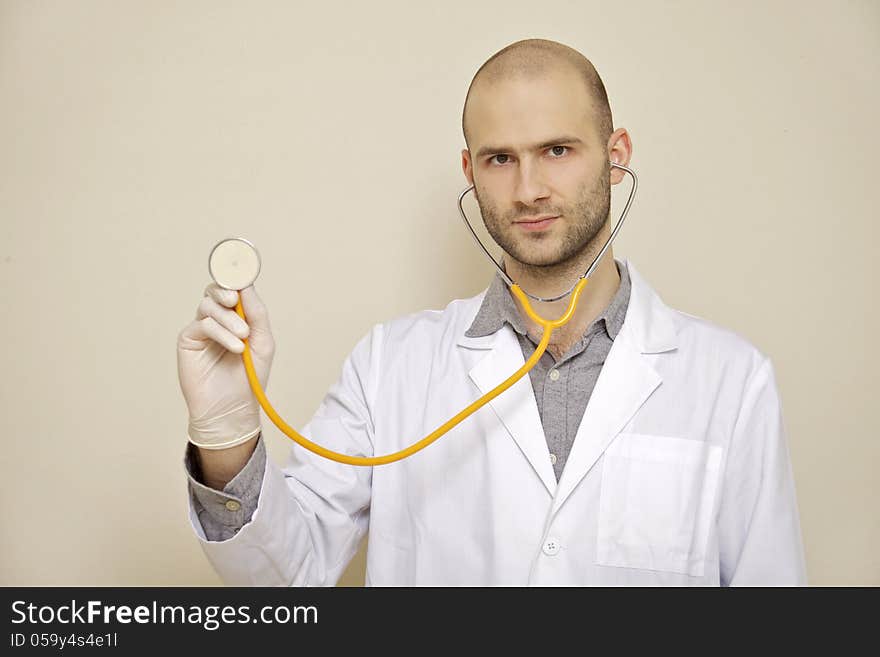 Portrait of a doctor of stethoscope isolated on light background