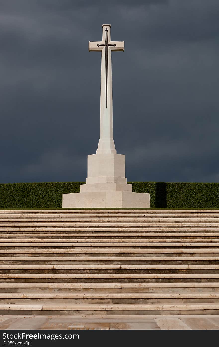 Large marble cross with a sword decoration at a war grave cemetery. Large marble cross with a sword decoration at a war grave cemetery