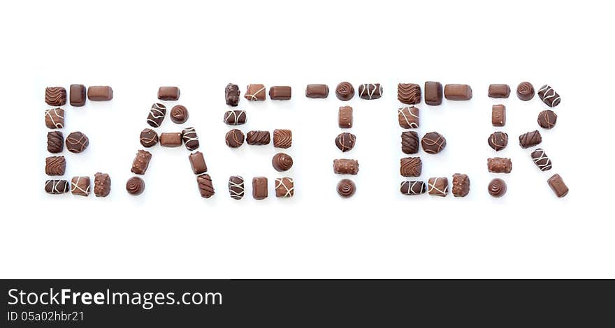 The word easter formed using chocolates over a white background. The word easter formed using chocolates over a white background