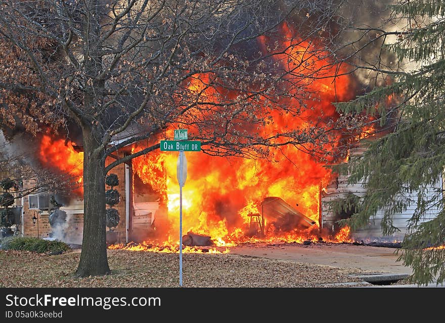 House fire with the garage fully engulfed in flames. House fire with the garage fully engulfed in flames