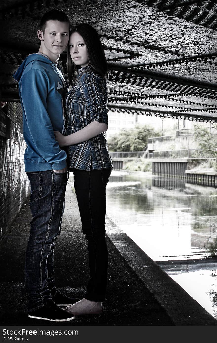 Young Cute Couple Hugging Under The Bridge