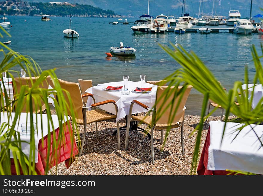 Restaurant tables on the Mediterranean Sea in the summer. Restaurant tables on the Mediterranean Sea in the summer